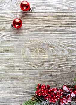 Red christmas balls and Christmas decoration on lower right side of wooden background
