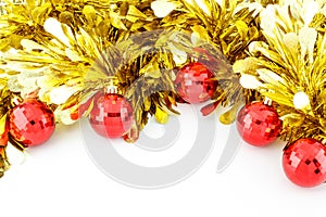 Red Christmas balls and golden tinsel.