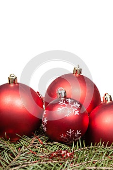 Red Christmas balls on green fir tree branch