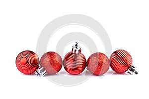 Red christmas balls horizontally on straight line