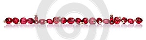 Red Christmas balls in a row side by side on white background