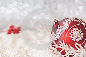 Red Christmas bauble on glitter background