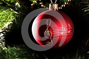 A red christmas bauble with musical notes