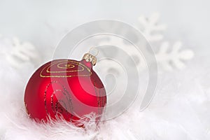 Red christmas bauble in the snow