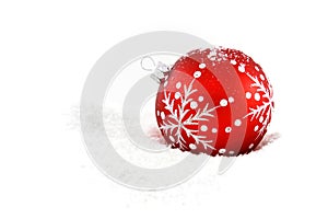 Red christmas bauble in snow