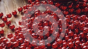 Red Christmas Beads on a Rustic Background
