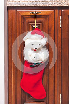 Red Christmas boot weighs on polished furniture