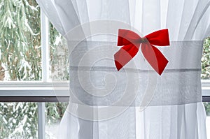 Red Christmas Bow on White Window Curtain