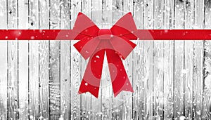 Red Christmas bow on wooden background