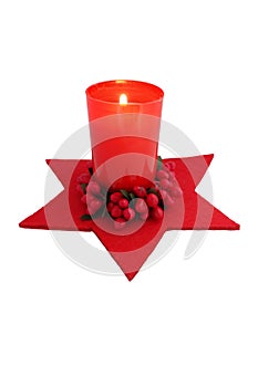 Red christmas candle with decorations isolated on white background