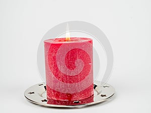 Red Christmas candle on a white background.