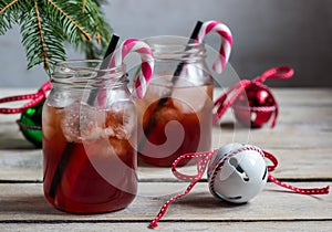 Red Christmas cocktail with candy cane and ice