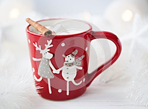 Red Christmas cup with cocoa and cinnamon and marshmellows