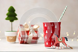 Red Christmas cup and festive wooden decor