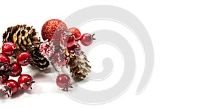 Red Christmas decoration, pine cone , frozen rose hips, red balls isolated on white background