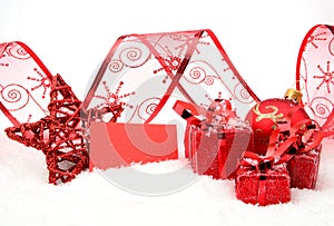Red christmas decoration with wishes card on snow