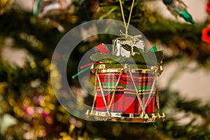 Red Christmas drum ornament hanging from Christmas tree