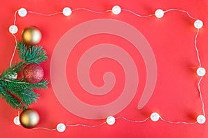 Red Christmas frame. Christmas decoration and lights on red background with copy space in the middle