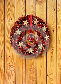 Red Christmas garland in old wooden door