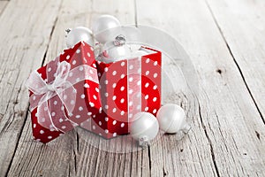 Red Christmas gift box full of xmas white bauble