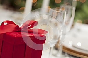 Red Christmas Gift with Place Setting at Table