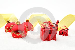 Red christmas gifts,baubles golden ribbon on snow