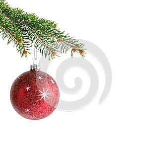 Red Christmas glass ball hanging on fir tree branch isolated on white