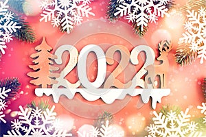 Red Christmas holidays background; greeting card , Christmas card with fir and decor on glitter background