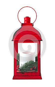 Red Christmas lantern with white candle with pine branches on a white background