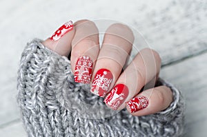 Red Christmas manicure with deer and snowflakes