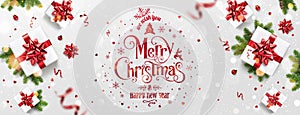 Red Christmas and New Year Text on Xmas background with gift boxes, fir branches, red ribbon, decoration, sparkles, confetti