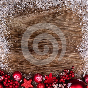 Red Christmas ornament bottom border with snow frame on wood