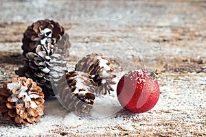 Red christmas ornament pine cones on wooden