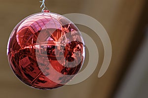 Red Christmas ornamental ball with close up of reflection