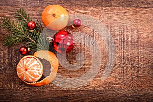 Red Christmas ornaments, food decor and fir tree branch on a rustic wooden background. Xmas card. Happy New Year