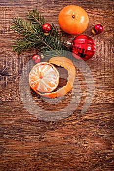 Red Christmas ornaments, food decor and fir tree branch on a rustic wooden background. Xmas card. Happy New Year. Top view