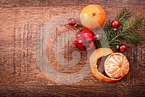 Red Christmas ornaments, food decor and fir tree branch on a rustic wooden background. Xmas card. Happy New Year. Top view