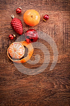 Red Christmas ornaments, food decor and fir tree branch on a rustic wooden background. Xmas card. Happy New Year. Top view