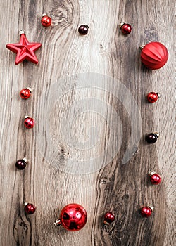 Red Christmas ornaments on a rustic wooden background. Xmas card