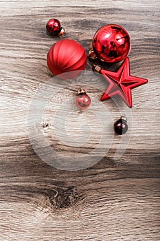 Red Christmas ornaments on a rustic wooden background. Xmas card. Happy New Year