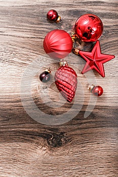 Red Christmas ornaments on a rustic wooden background. Xmas card. Happy New Year