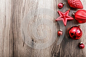 Red Christmas ornaments on a rustic wooden background. Xmas card. Happy New Year