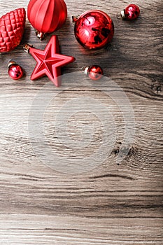 Red Christmas ornaments on a rustic wooden background. Xmas card. Happy New Year