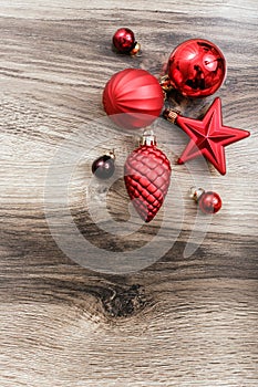 Red Christmas ornaments on a rustic wooden background. Xmas card. Happy New Year. Top view