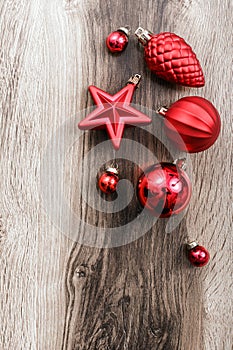 Red Christmas ornaments on a rustic wooden background. Xmas card. Happy New Year. Top view