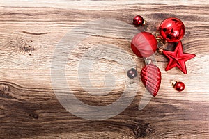 Red Christmas ornaments on a rustic wooden background. Xmas card. Happy New Year. Top view