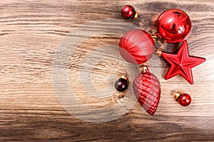 Red Christmas ornaments on a rustic wooden background. Xmas card. Happy New Year. Top view