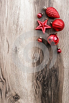 Red Christmas ornaments on a rustic wooden background. Xmas card. Happy New Year. Top view