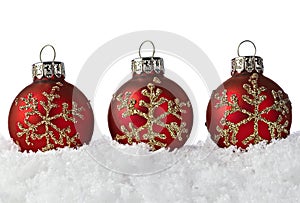 Red Christmas Ornaments With Snowflakes On Snow