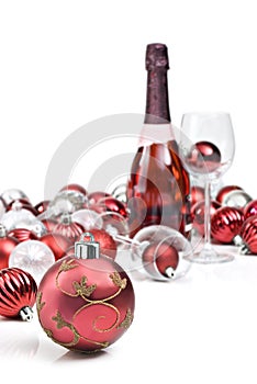 Red christmas ornaments with sparkling wine